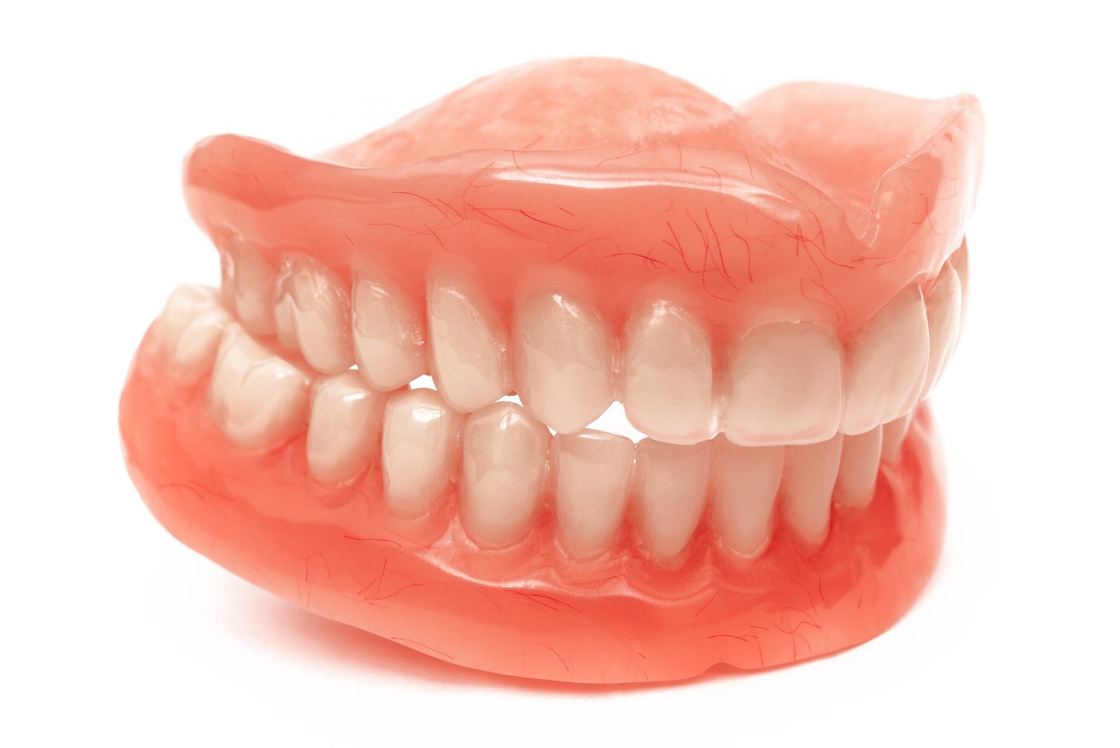 Two acrylic dentures. Upper and lower jaws with fake teeth. Dentures or false teeth, close-up